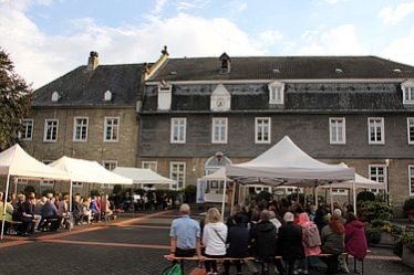 Gottesdienstbesucher vor dem Haus Düsse